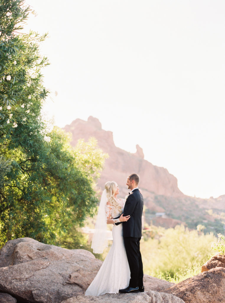 sanctuary wedding photo with praying monk in the background, arizona wedding venue